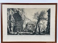 Full view of framed black and white vintage etching showing Arch of Titus with architectural details and people in street scene.