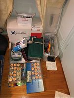 Overall view of Janome box, storage containers, thread and notions on floor