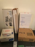 Overview of five boxed items including frame holder, spool rack, light set, AG10 and FC6 carriages