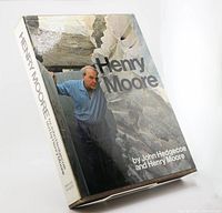 Front and spine of large hardcover book with dust jacket showing Henry Moore amid stone sculptures, in original slipcase.