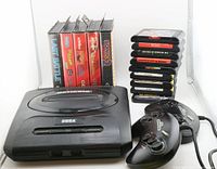 Overall lot showing Sega Genesis console, two controllers, boxed and loose games.
