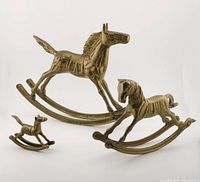Set of 3 brass rocking horse figurines arranged on white background for scale and condition display.