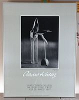 Framed black and white photographic exhibition poster by André Kertész showing the full image of a drooping tulip and a glass vase, with exhibition dates and gallery name below.