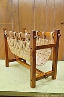 Front and side view of split weave wooden magazine rack showing woven basket and wood pins