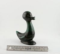 Front and side views of the vintage ceramic duck by Blue Mountain Pottery with ruler for scale.