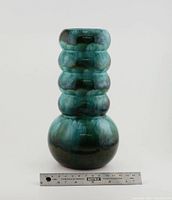 Front view of the vintage Blue Mountain Pottery ring vase displaying its detailed shape and glazed finish with a ruler for scale.