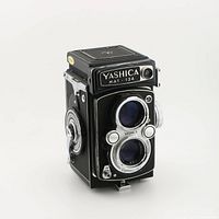 Front view of Yashica Mat 124 twin lens reflex camera showing twin lenses and front controls.
