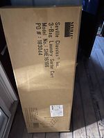 Box labeled Seville Classics 3-Bag Laundry Sorter Cart, model SHE16166, showing product packaging and condition as new.
