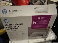 Box of HP DeskJet 2742e printer showing product branding and service info