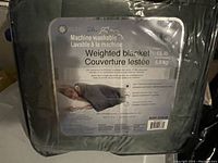 Photo of packaged weighted blanket with label showing machine washable instructions and 15 lb weight.