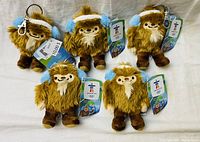 All five Quatchi plush key chains shown together on white background.
