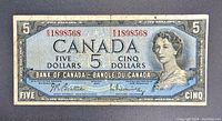 Front view of 1954 Canadian five dollar bill with Queen Elizabeth II portrait, serial number, and text.