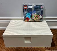 Photo of white IKEA building block storage box with the sealed LEGO VIP Lunar New Year Add-On Pack placed on top.