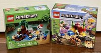 Front view of both sealed Lego Minecraft sets side by side showing box art and piece count.