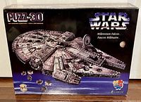Front of the sealed puzzle box showing the Millennium Falcon 3D puzzle image with piece count and branding.