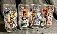 Four vintage Star Wars Empire Strikes Back themed glasses with character illustrations, front view showing detailed colorful graphics.