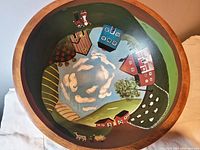 Top view of the hand-painted interior depicting a scenic rural landscape with houses, trees, animals, fields, and sky.