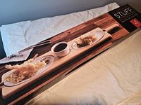 Original box packaging showing Kitchen Stuff Plus Glenmore serving set with images of tray, plates, and bowl.