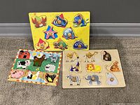 Three animal matching puzzles for kids placed side by side on carpet