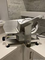 Front-angled view showing slicer body, carriage and base