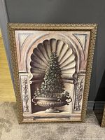 Front view of wall art showing topiary artwork within ornate gold frame