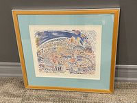 Framed limited edition print with a gold frame and light blue mat showing a detailed stadium scene with crowds at the Sydney 2000 Paralympics Opening Ceremony.