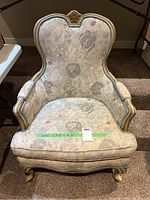 Front view of the French tub accent chair showing fabric pattern, wooden frame, and overall condition.