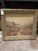 Framed landscape painting with label showing measurements of 33x29 inches and lot number sticker.