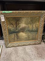 Full view of the large framed vintage landscape painting showing the scene and ornate gold frame.