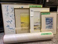 Four framed artworks arranged leaning against a surface with three rolled posters labeled '3 x Poster' in front. Measurements for individual frames noted on green tape: 24 x 18.5 inches and 11.5 x 15 inches.