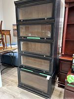 Full view of black two-piece barrister bookcase with stacked glass-front compartments