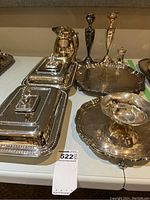 Complete view of all items including trays, entrée dishes, sugar bowl, candlesticks, and shaker.