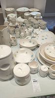 Wide view of complete dinnerware set on table