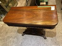 Top view of the compact wooden table with rich wood grain visible and Masold measurement sticker showing dimensions.