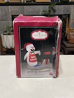 Front view of the box showing the image of the inflatable snowman with grill and the Trim A Home brand indicator.