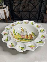 Full top view of the handpainted deviled egg plate showing the scalloped edges and fruit design.