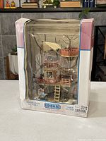 Front view of the LEMAX Village Collection 2004 treehouse decoration in box showing the item and box wear.