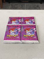 Four sealed MetaZoo Series 1 booster packs laid out on a flat surface, showing the front packaging artwork and MetaZoo branding.