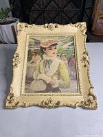 Frontal view of the vintage Jeffe Huldah framed textured print showing a Victorian woman and ornate cream and gold frame.