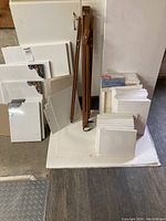 Overall view of all canvas stacks and folded easel on white base