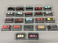 Top-down view of full toy car collection, all in display cases showing color and model variety.