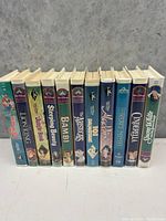 Side view of 14 Disney Black Diamond VHS tapes arranged upright showing spine titles and Disney Black Diamond logo.