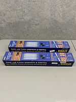 Top view of two blue boxes labeled 'Arthur Drain Cleaner Extension Kit' showing product and usage images