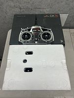 Spektrum DX7s black packaging box with white styrofoam insert.