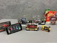 Overview photo showing all toy cars and motorcycles in original packaging, including boxed sets and display cases.