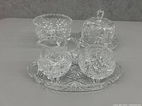 Full set of pinwheels crystal glassware including pitcher, covered butter dish, footed bowl, small bowl, and serving tray.