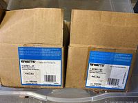 Two Watts Series 007 Double Check Valve Assembly boxes showing product label with model number 1 007M1 - QT and product details.