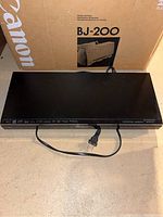 Panasonic Blu-ray Disc player showing top view with power cord, black color.