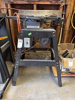 Front view of Rockwell Beaver jointer mounted on metal stand showing power cord and motor under table.