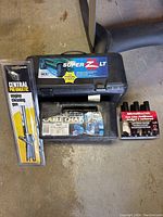 Overview of all items, showing tire chains case, antifreeze box, and engine cleaning gun packaging.